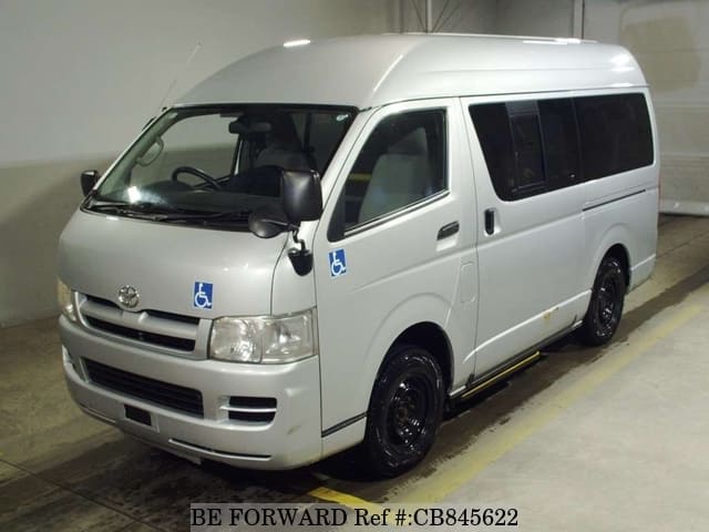 A grey JDM sports car speeding down a highway at night.