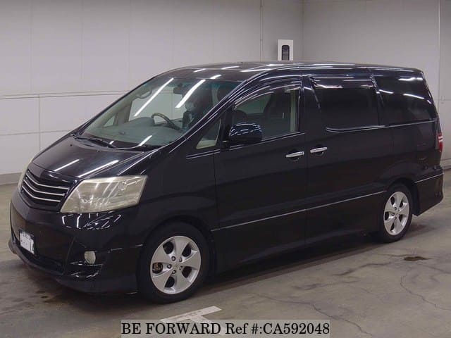 A grey JDM sports car speeding down a highway at night.