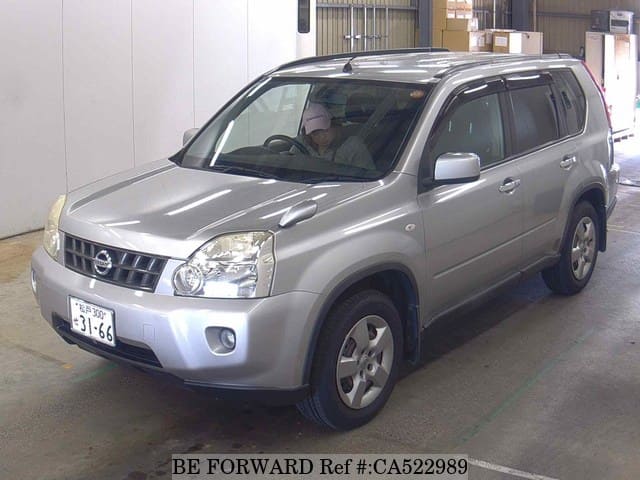 A grey JDM sports car speeding down a highway at night.