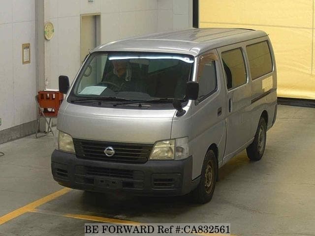 A grey JDM sports car speeding down a highway at night.