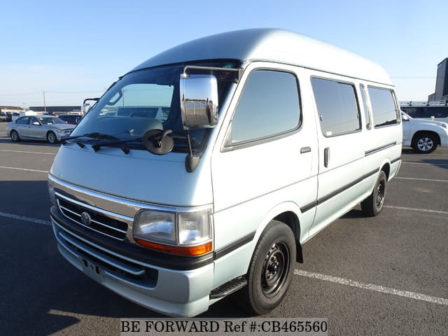 A grey JDM sports car speeding down a highway at night.