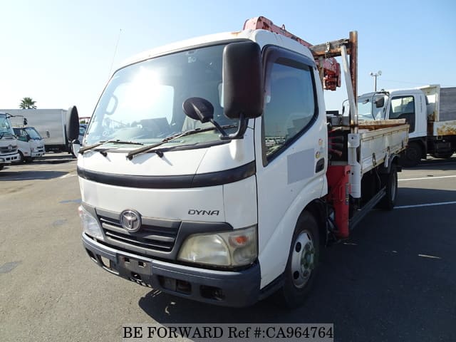 A grey JDM sports car speeding down a highway at night.