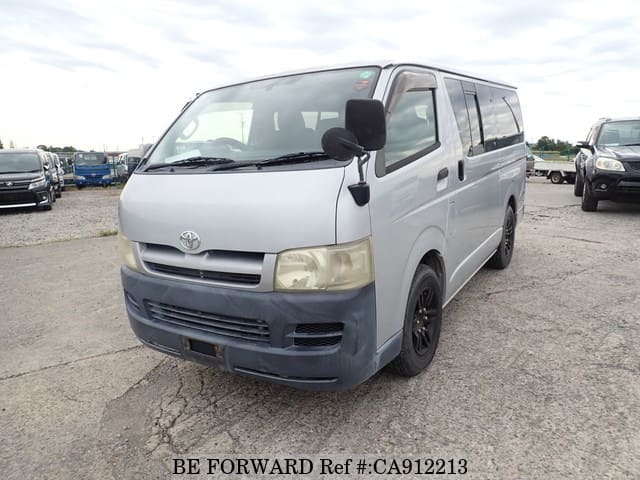 A grey JDM sports car speeding down a highway at night.