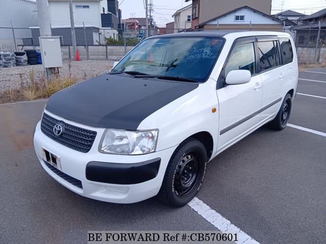 A grey JDM sports car speeding down a highway at night.