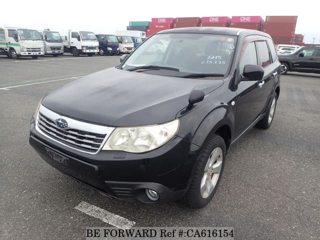 A grey JDM sports car speeding down a highway at night.