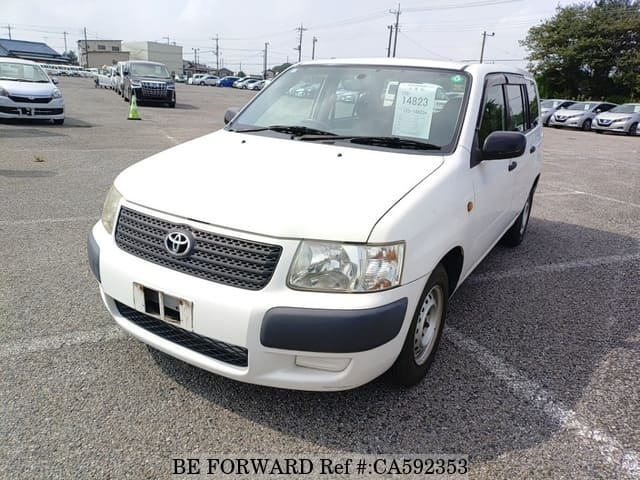 A grey JDM sports car speeding down a highway at night.