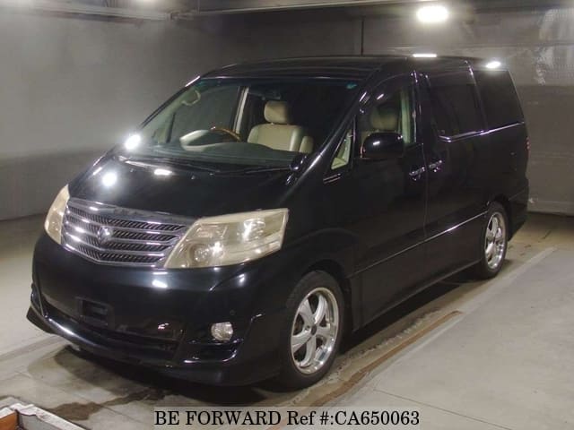 A grey JDM sports car speeding down a highway at night.
