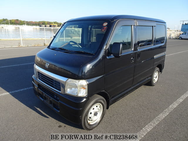 A grey JDM sports car speeding down a highway at night.