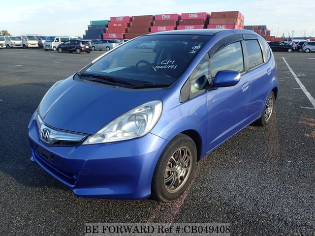 A grey JDM sports car speeding down a highway at night.