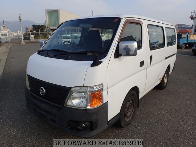 A grey JDM sports car speeding down a highway at night.
