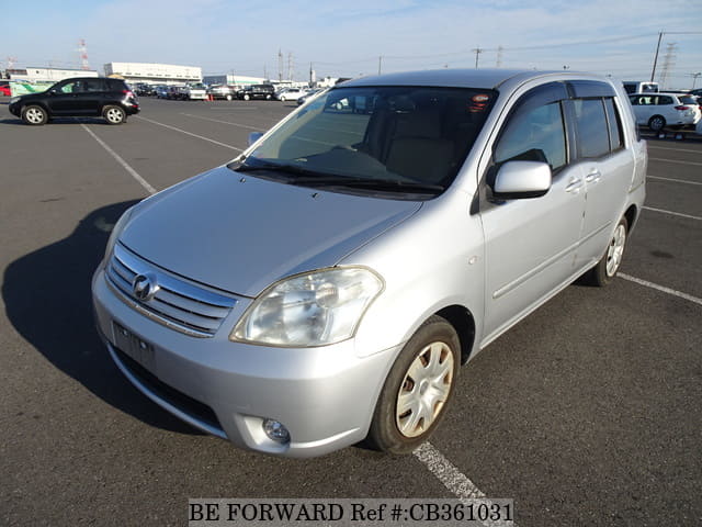A grey JDM sports car speeding down a highway at night.