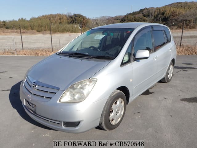 A grey JDM sports car speeding down a highway at night.