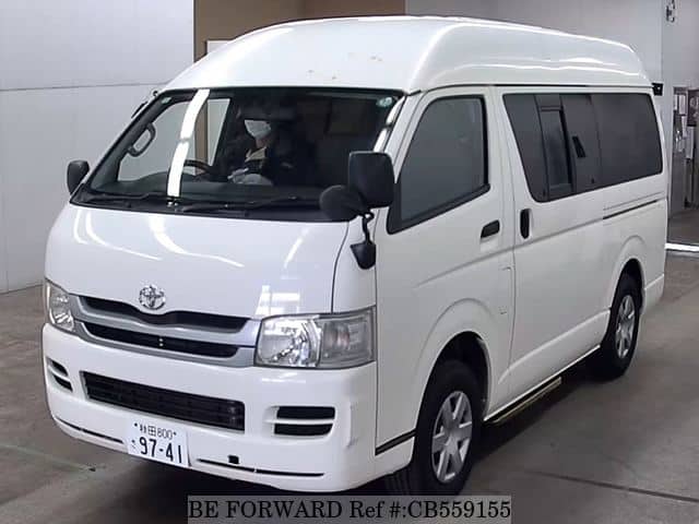A grey JDM sports car speeding down a highway at night.
