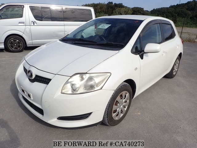 A grey JDM sports car speeding down a highway at night.