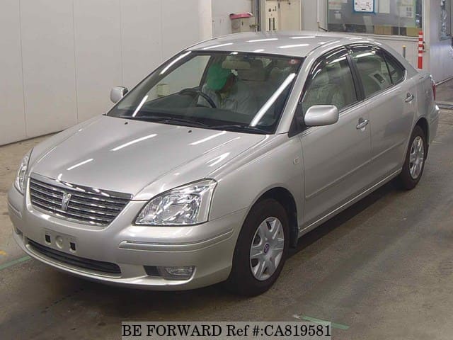 A grey JDM sports car speeding down a highway at night.