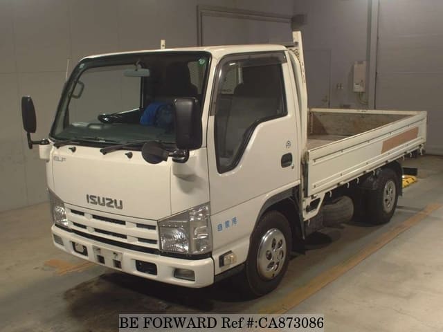 A grey JDM sports car speeding down a highway at night.