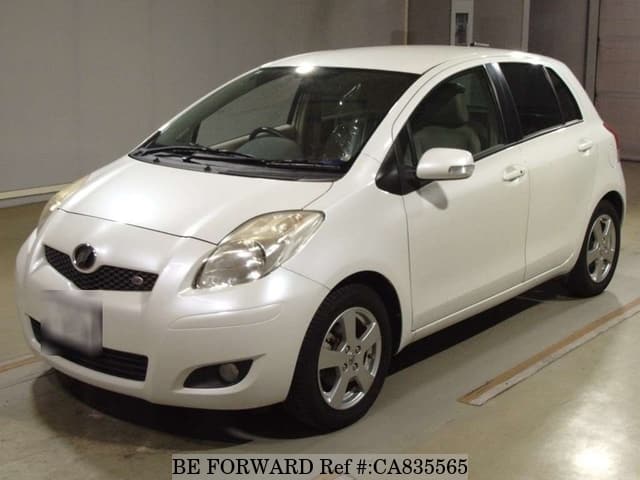 A grey JDM sports car speeding down a highway at night.