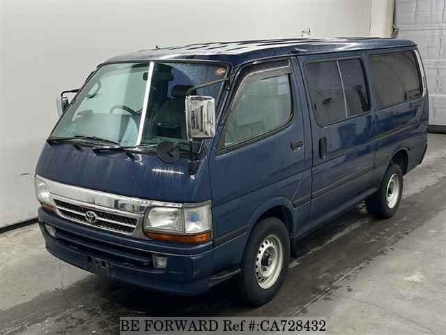 A grey JDM sports car speeding down a highway at night.