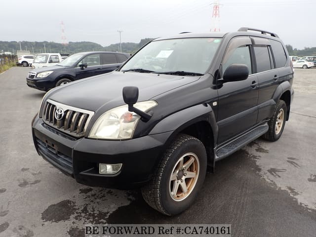 A grey JDM sports car speeding down a highway at night.
