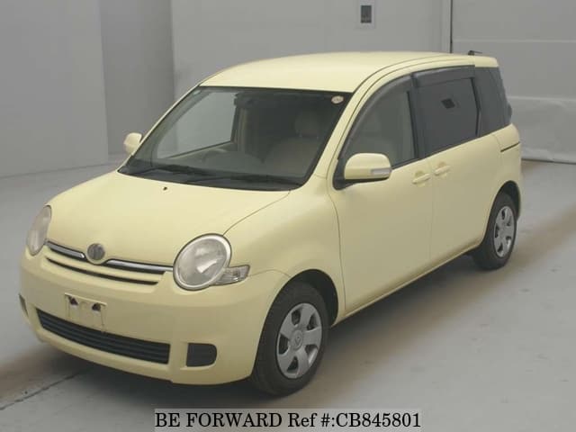 A grey JDM sports car speeding down a highway at night.