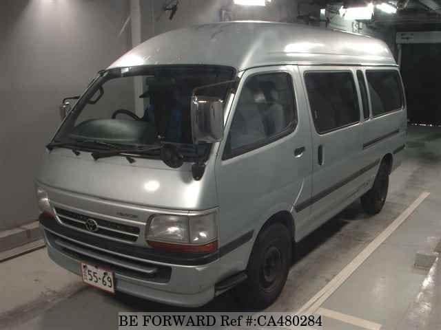 A grey JDM sports car speeding down a highway at night.