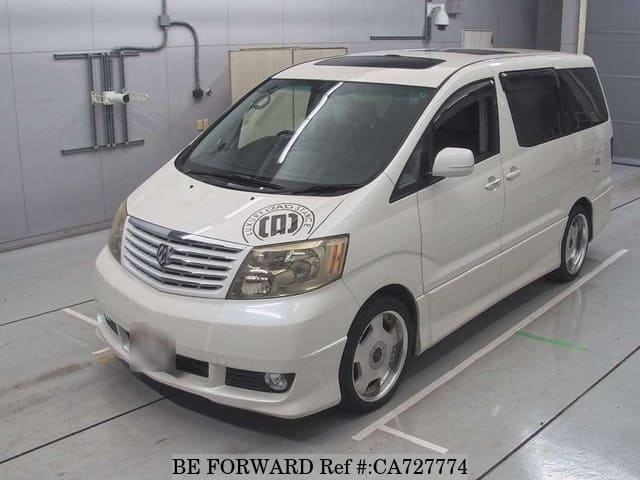 A grey JDM sports car speeding down a highway at night.
