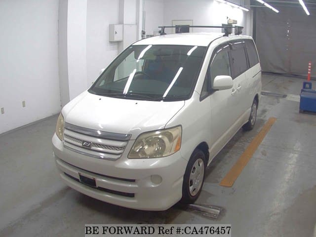 A grey JDM sports car speeding down a highway at night.