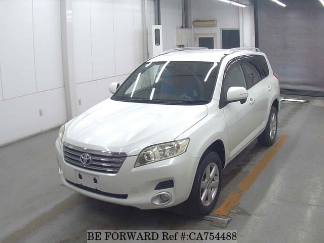 A grey JDM sports car speeding down a highway at night.