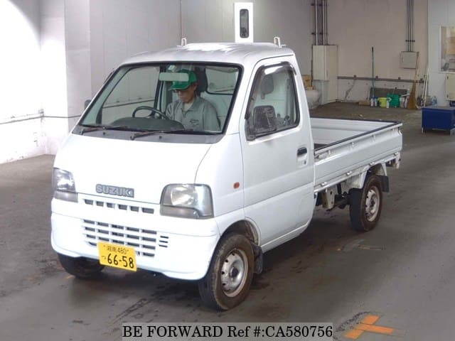 A grey JDM sports car speeding down a highway at night.