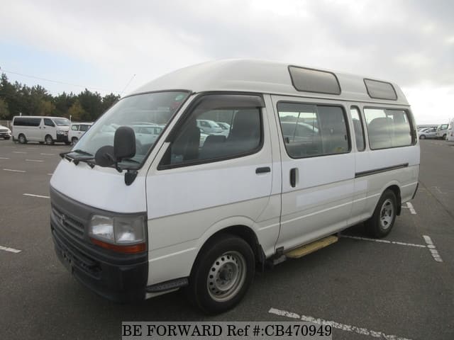 A grey JDM sports car speeding down a highway at night.