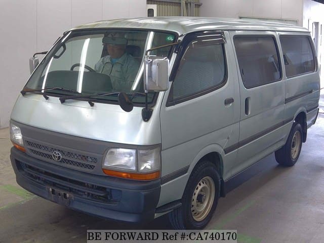 A grey JDM sports car speeding down a highway at night.