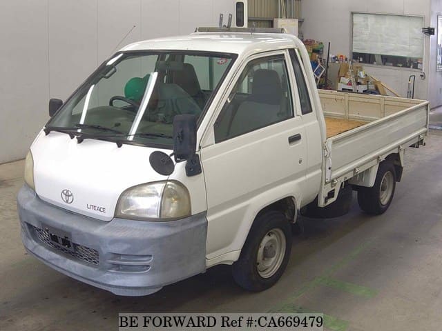 A grey JDM sports car speeding down a highway at night.