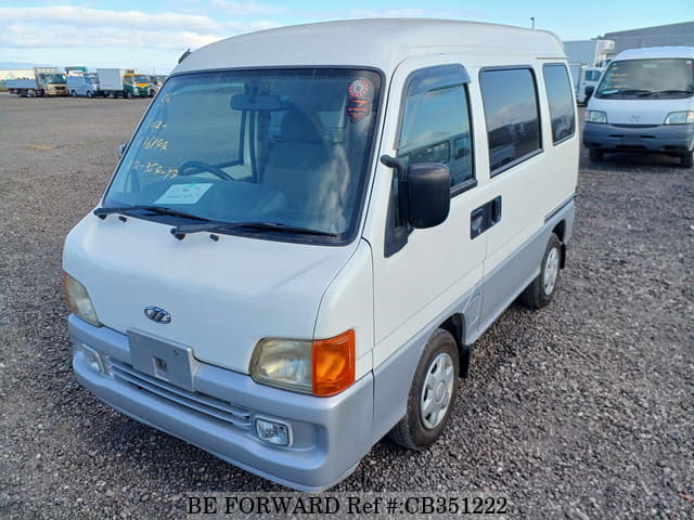 A grey JDM sports car speeding down a highway at night.