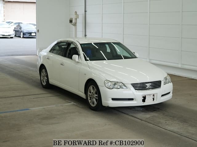 A grey JDM sports car speeding down a highway at night.