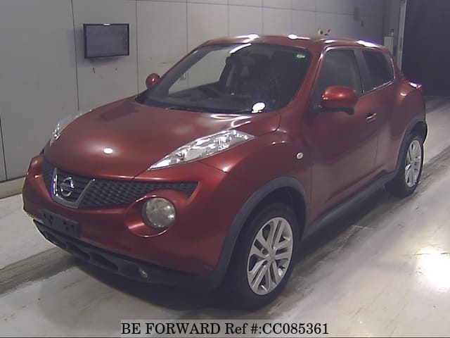 A grey sports car speeding down a highway at night.