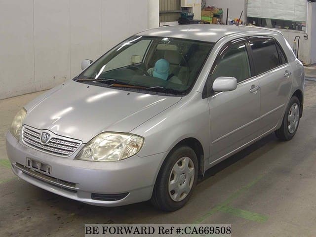 A grey JDM sports car speeding down a highway at night.