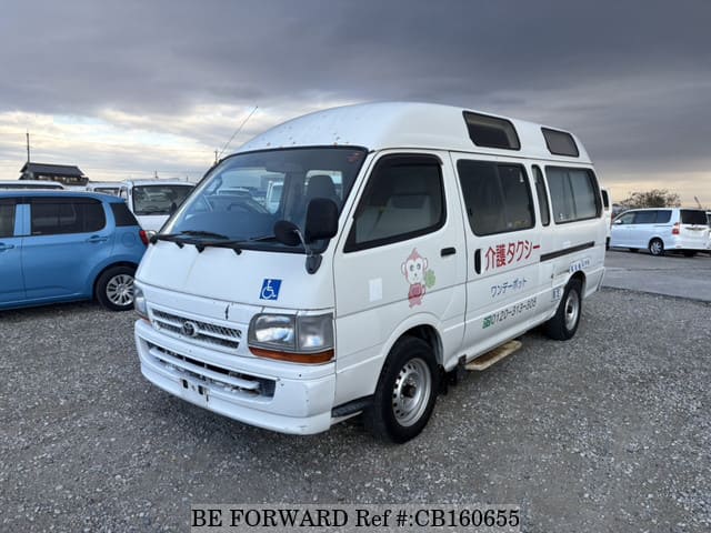 A grey JDM sports car speeding down a highway at night.