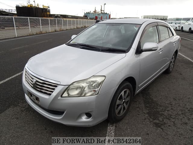 A grey JDM sports car speeding down a highway at night.