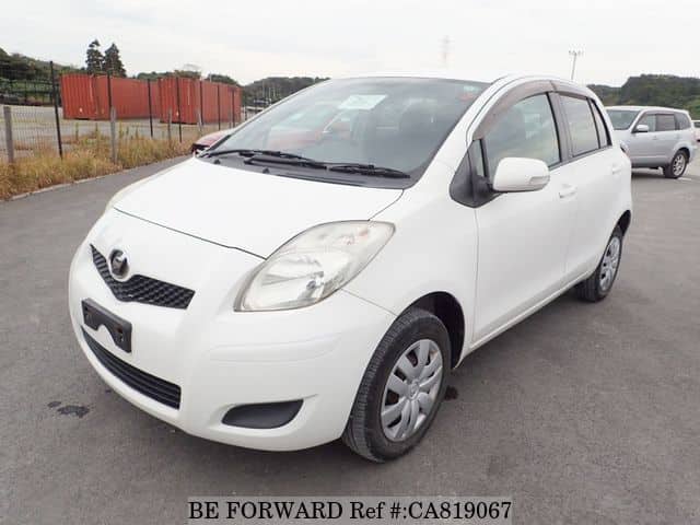 A grey JDM sports car speeding down a highway at night.