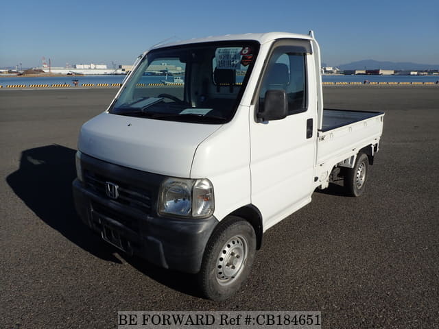 A grey JDM sports car speeding down a highway at night.