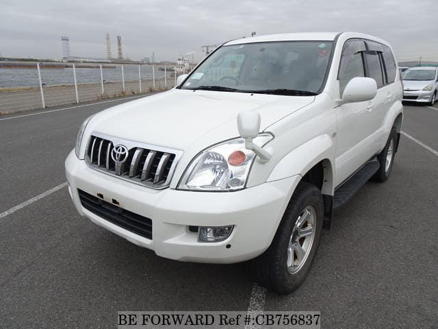 A grey JDM sports car speeding down a highway at night.