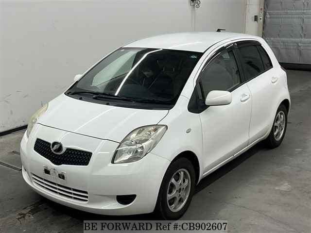 A grey JDM sports car speeding down a highway at night.