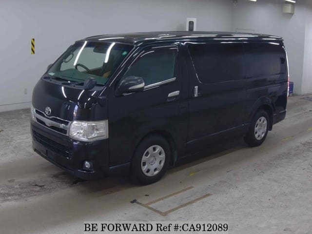 A grey JDM sports car speeding down a highway at night.