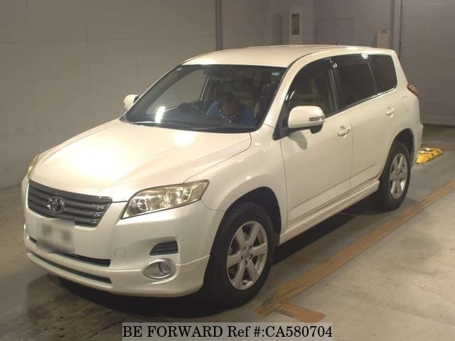 A grey JDM sports car speeding down a highway at night.