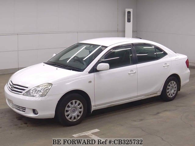 A grey JDM sports car speeding down a highway at night.