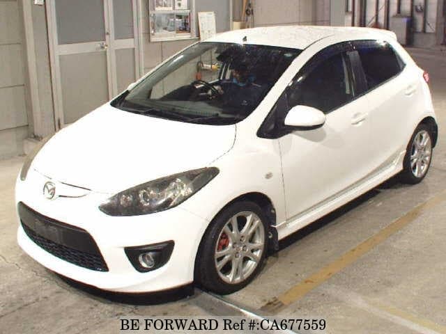A grey JDM sports car speeding down a highway at night.