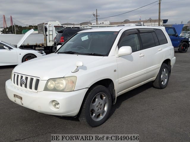 A grey JDM sports car speeding down a highway at night.