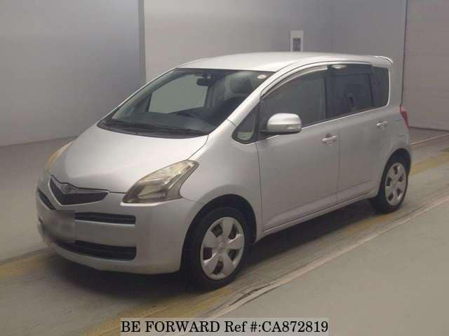 A grey JDM sports car speeding down a highway at night.