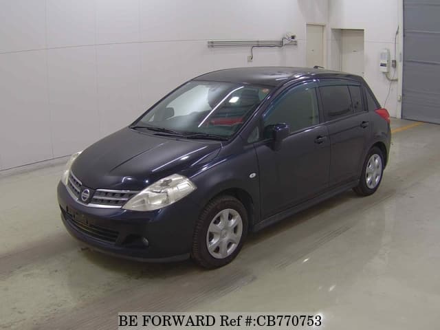 A grey JDM sports car speeding down a highway at night.