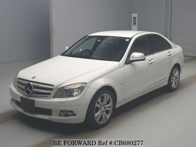 A grey JDM sports car speeding down a highway at night.